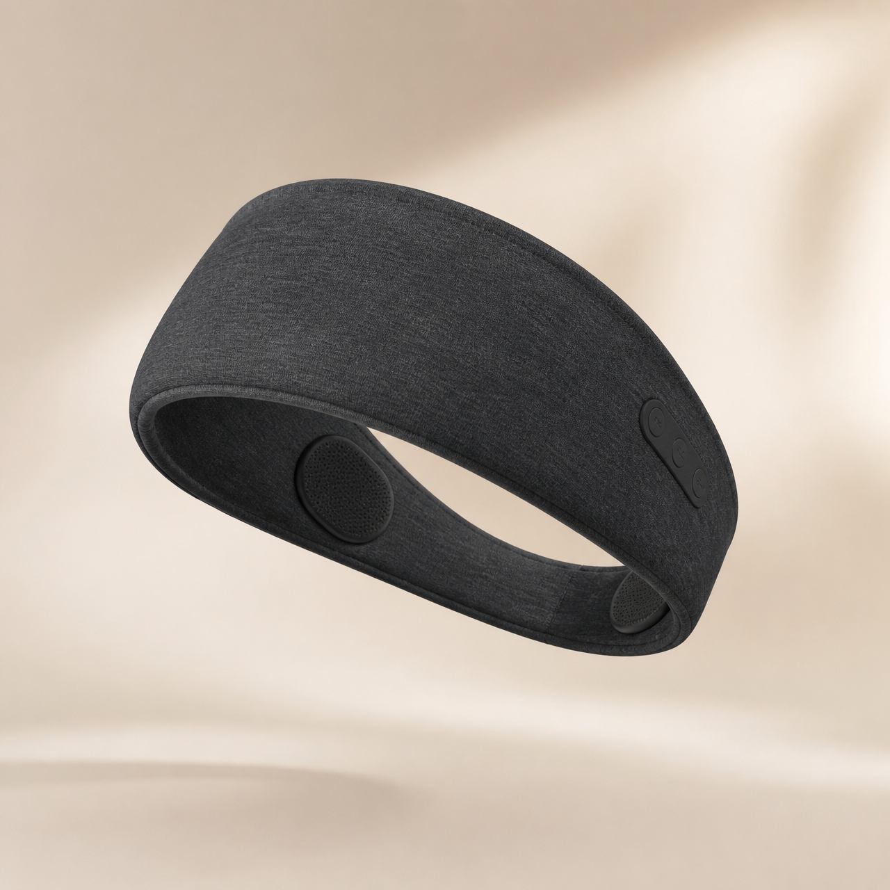 DreamBand Bluetooth sleep headband floating at an angle showing the soft fabric and wireless controls